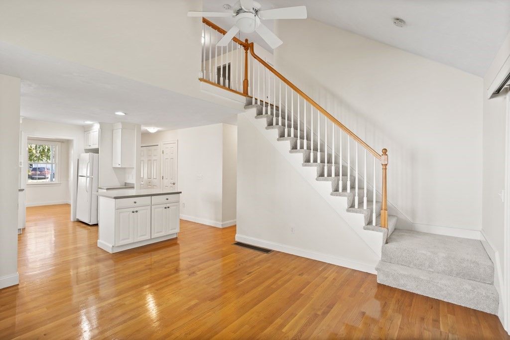 114 Summer Road, Unit 114 Boxborough, MA 01719 - Photo 19 of 42 a view of an entryway wooden floor and a living room
