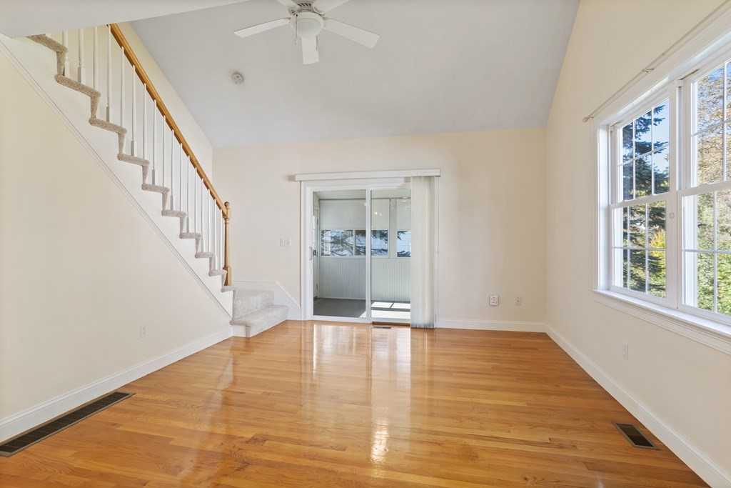 114 Summer Road, Unit 114 Boxborough, MA 01719 - Photo 22 of 42 a view of an empty room with wooden floor and a window