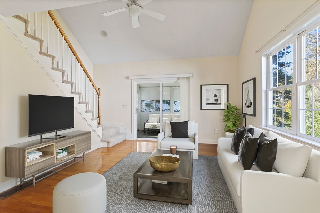 114 Summer Road, Unit 114 Boxborough, MA 01719 - Photo 23 of 42 a living room with furniture and a flat screen tv
