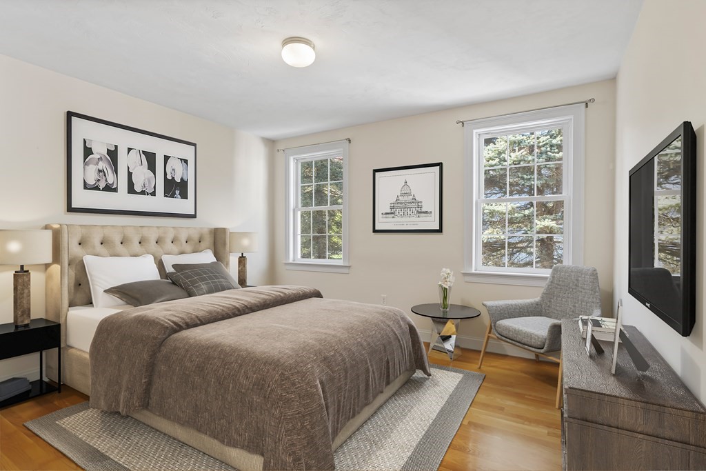 114 Summer Road, Unit 114 Boxborough, MA 01719 - Photo 27 of 42 a spacious bedroom with a bed a couch and a window