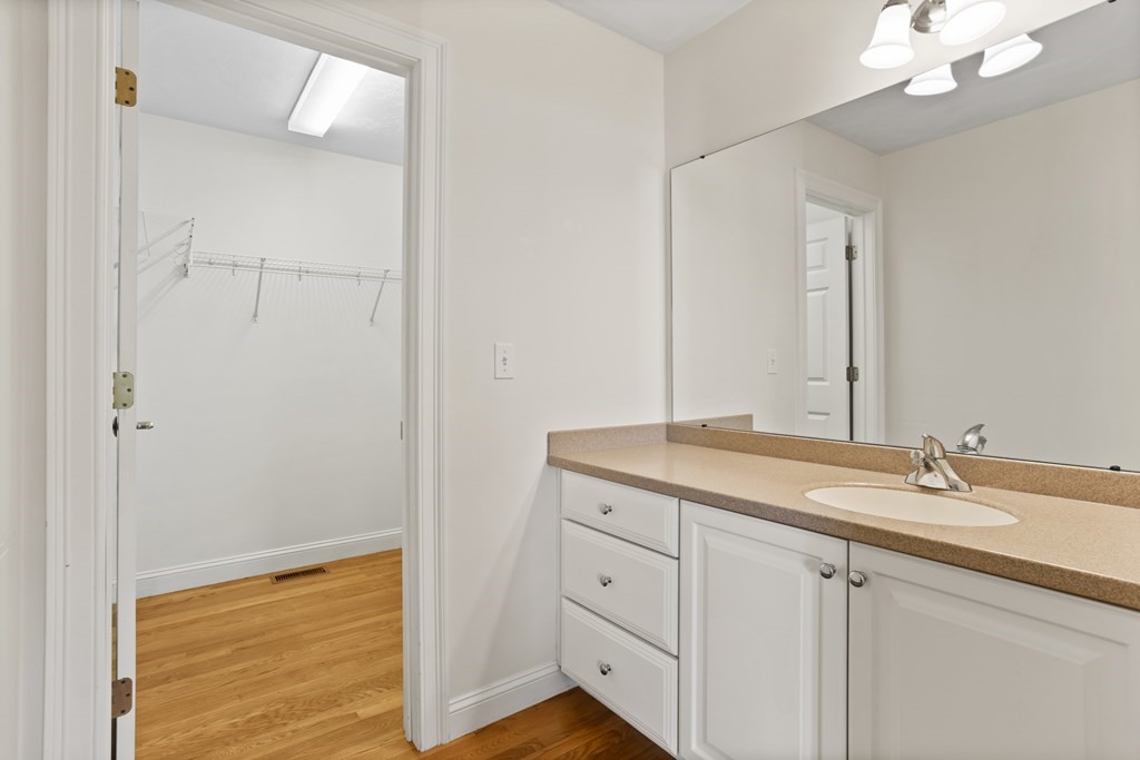 114 Summer Road, Unit 114 Boxborough, MA 01719 - Photo 30 of 42 a bathroom with a granite countertop sink a mirror and a shower
