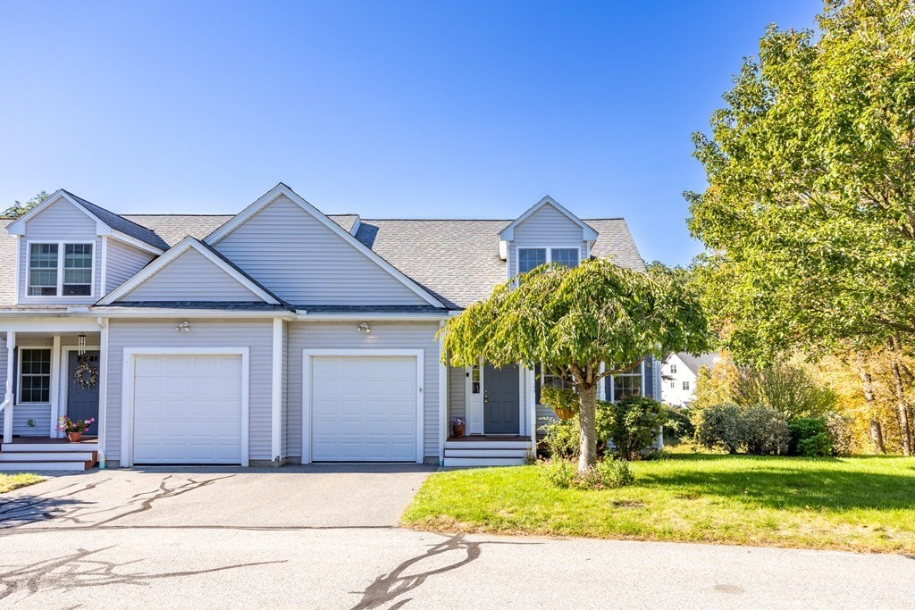 114 Summer Road, Unit 114 Boxborough, MA 01719 - Photo 3 of 42 a front view of a house with a garden and yard