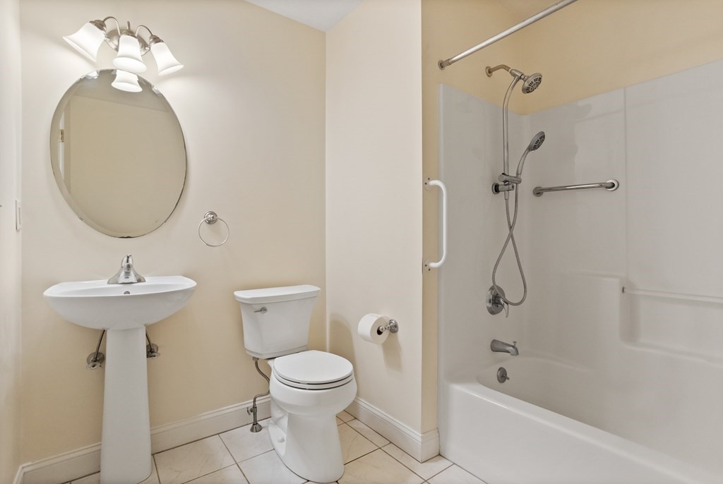 114 Summer Road, Unit 114 Boxborough, MA 01719 - Photo 32 of 42 a bathroom with a sink a toilet and shower