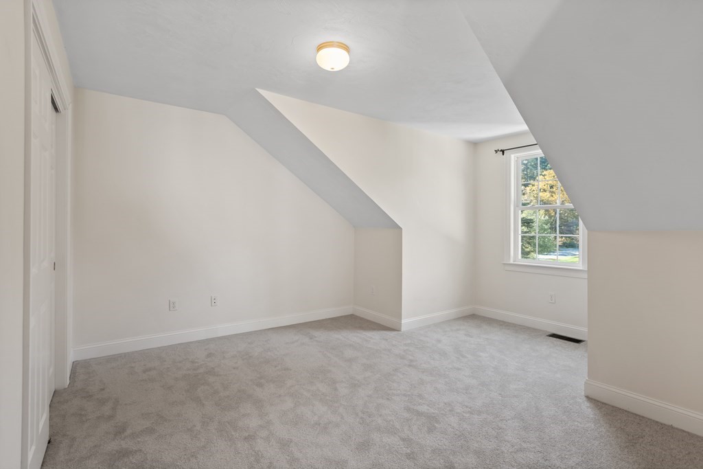 114 Summer Road, Unit 114 Boxborough, MA 01719 - Photo 34 of 42 an empty room with windows and entrance