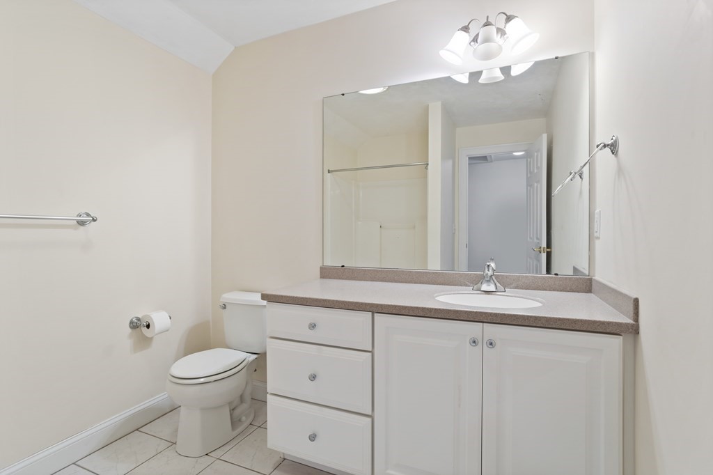 114 Summer Road, Unit 114 Boxborough, MA 01719 - Photo 38 of 42 a bathroom with a toilet a sink and mirror