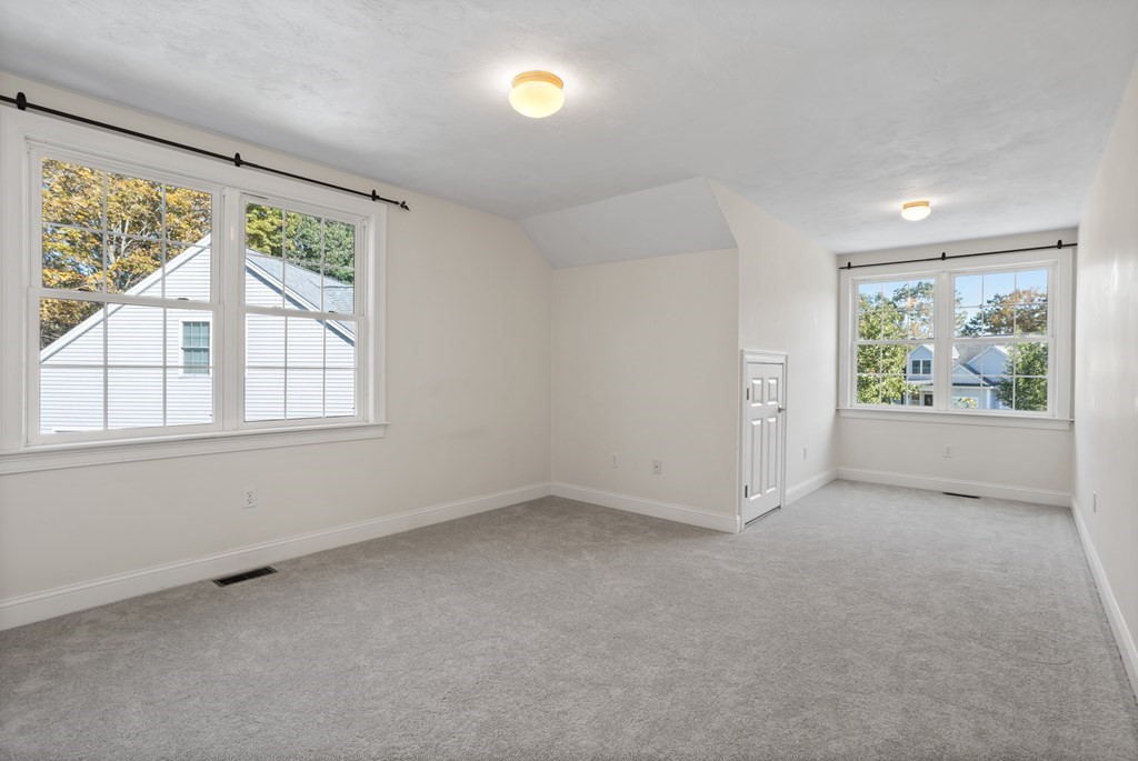 114 Summer Road, Unit 114 Boxborough, MA 01719 - Photo 40 of 42 an empty room with windows