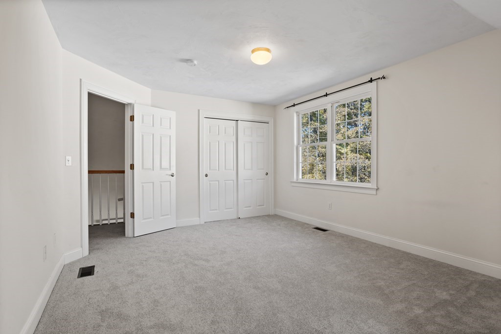 114 Summer Road, Unit 114 Boxborough, MA 01719 - Photo 41 of 42 an empty room with windows