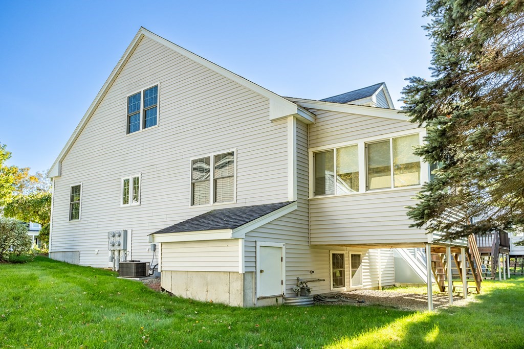 114 Summer Road, Unit 114 Boxborough, MA 01719 - Photo 5 of 42 a view of backyard of house with garden