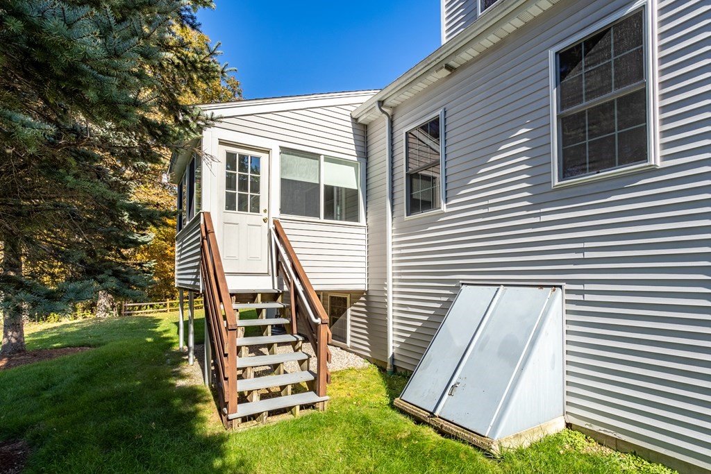 114 Summer Road, Unit 114 Boxborough, MA 01719 - Photo 6 of 42 a front view of a house with a yard