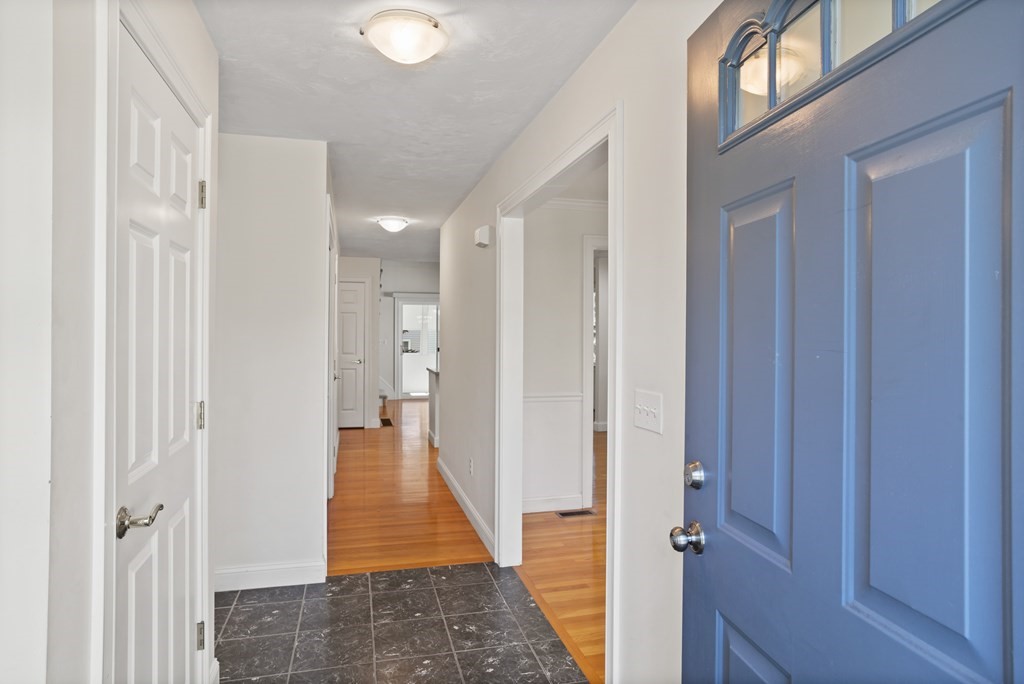 114 Summer Road, Unit 114 Boxborough, MA 01719 - Photo 7 of 42 a view of a hallway with wooden floor and staircase