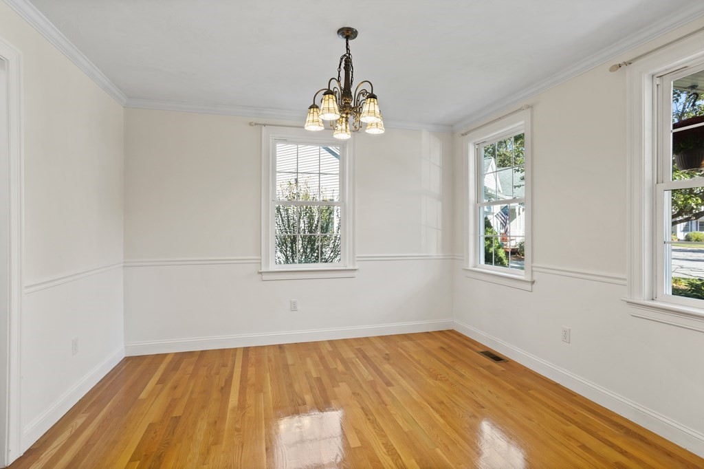 114 Summer Road, Unit 114 Boxborough, MA 01719 - Photo 8 of 42 a view of an empty room with wooden floor and a window