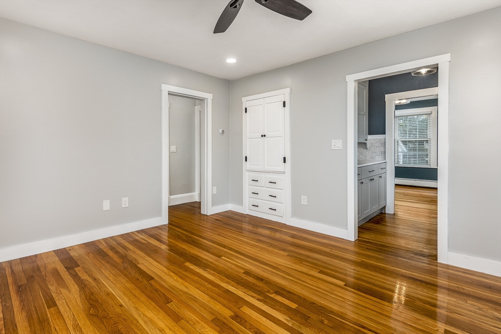 22 Clovelly Street Lynn, MA 01902 - Photo 17 of 28 a view of an empty room with wooden floor and a ceiling fan