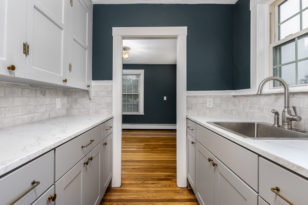 22 Clovelly Street Lynn, MA 01902 - Photo 21 of 28 a kitchen with granite countertop a sink and cabinets