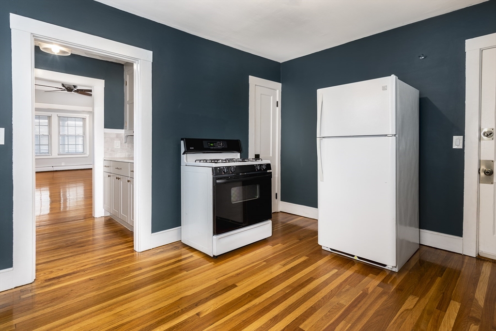 22 Clovelly Street Lynn, MA 01902 - Photo 22 of 28 a kitchen with granite countertop a refrigerator and a stove
