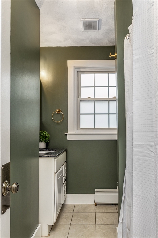 22 Clovelly Street Lynn, MA 01902 - Photo 24 of 28 a bathroom with a sink a toilet and window