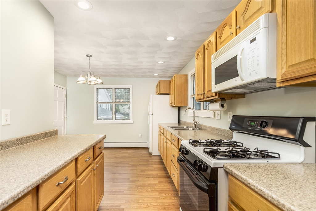 22 Clovelly Street Lynn, MA 01902 - Photo 7 of 28 a kitchen with a stove and a sink