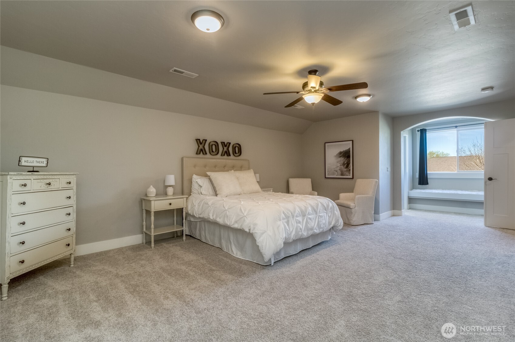 341 Reserve Way Walla Walla, WA 99362 - Photo 26 of 40 a spacious bedroom with a bed and a chandelier