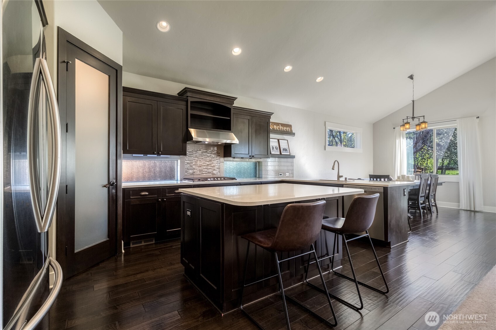 341 Reserve Way Walla Walla, WA 99362 - Photo 9 of 40 a kitchen with stainless steel appliances granite countertop a table chairs sink refrigerator and microwave