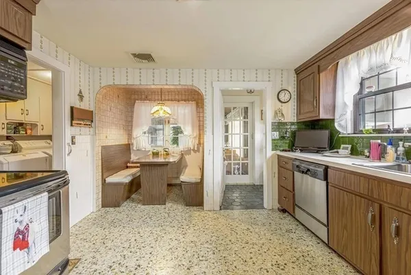 a kitchen with stainless steel appliances granite countertop a refrigerator and stove