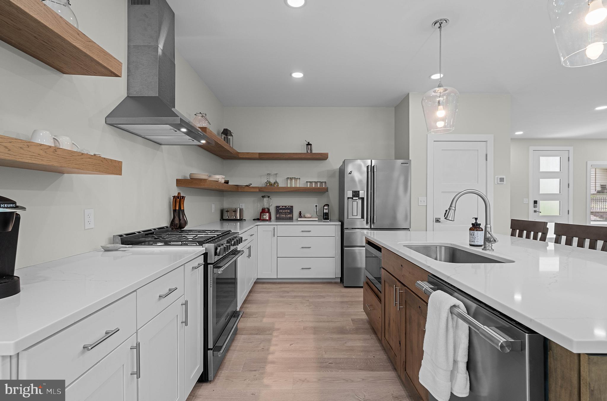 a kitchen with stainless steel appliances granite countertop a sink stove and cabinets