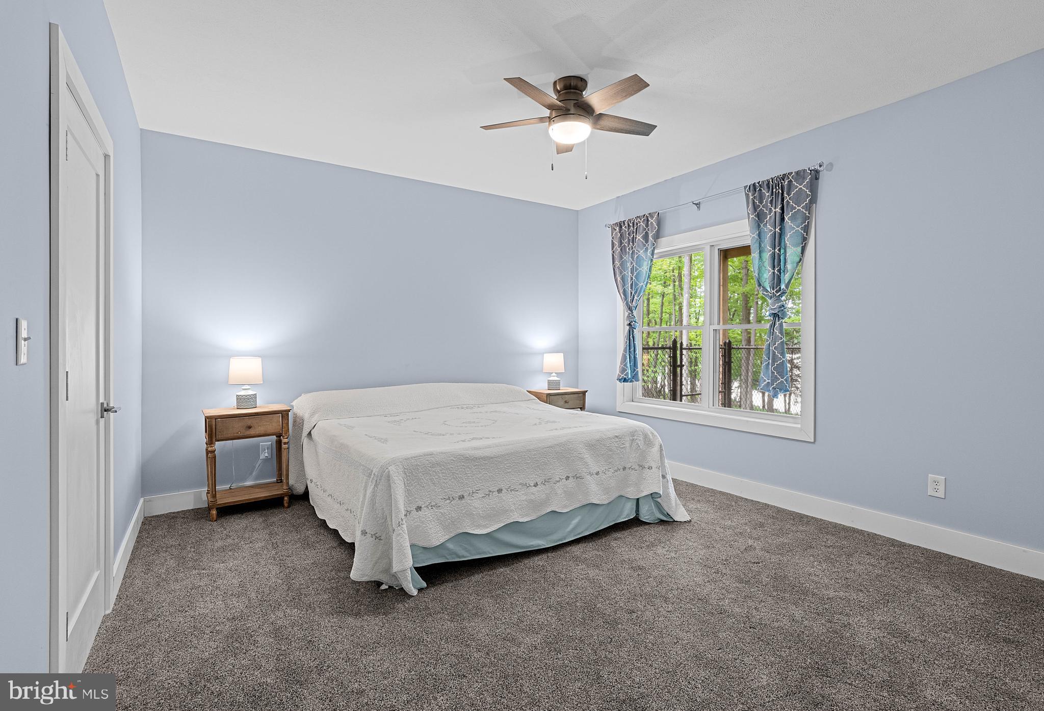 2645 Carribean Road Du Bois, PA 15801 - Photo 36 of 55 a spacious bedroom with a bed and a chandelier