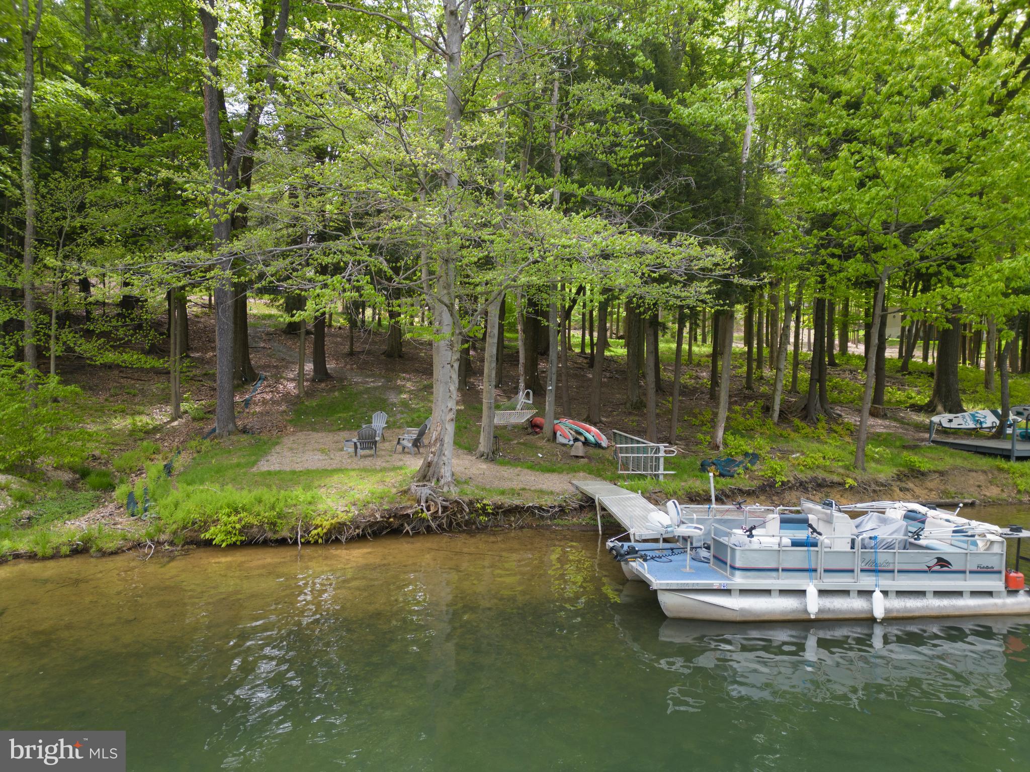 2645 Carribean Road Du Bois, PA 15801 - Photo 6 of 55 a view of a lake with a bench and trees