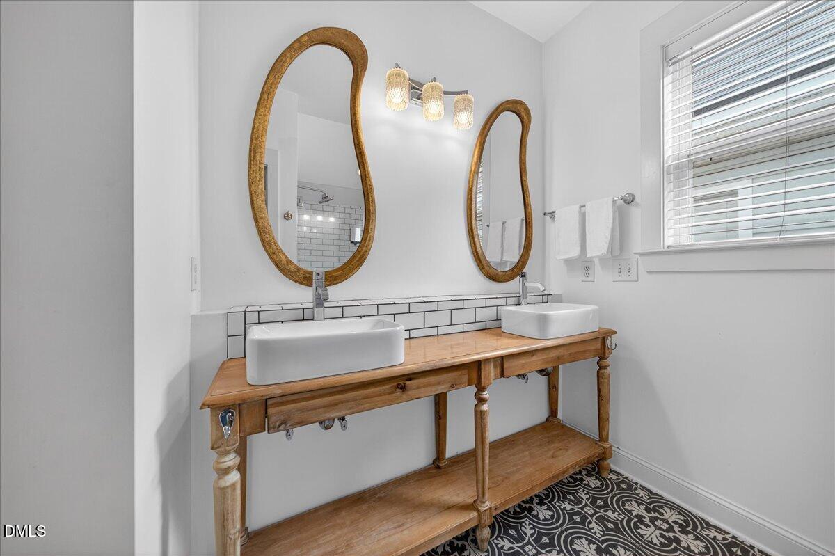 2116 Dunn Road Raleigh, NC 27614 - Photo 13 of 22 a bathroom with a sink and a mirror