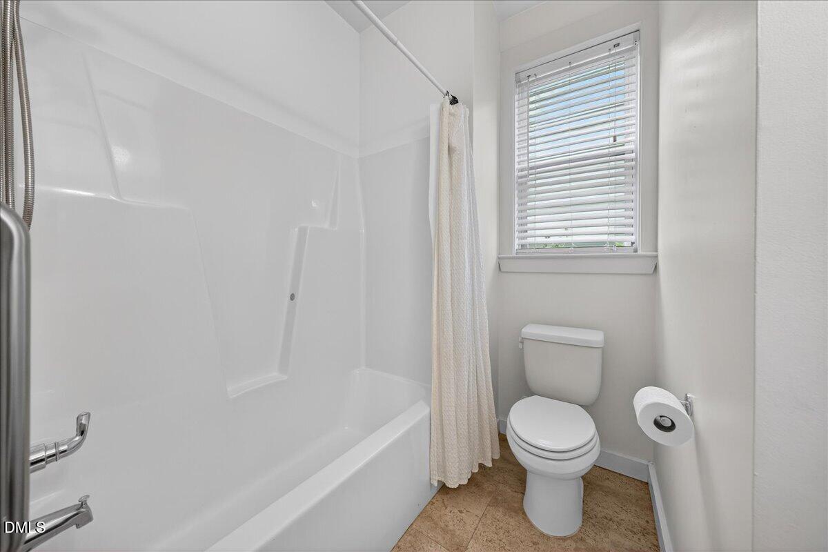 2116 Dunn Road Raleigh, NC 27614 - Photo 18 of 22 a bathroom with a toilet and a bathtub