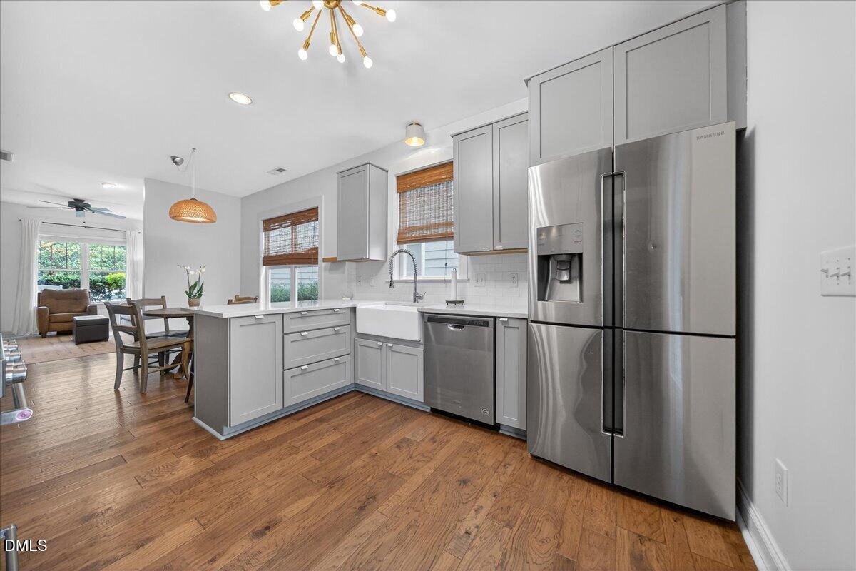 2116 Dunn Road Raleigh, NC 27614 - Photo 8 of 22 a kitchen with a refrigerator a sink dishwasher and a stove with wooden floor