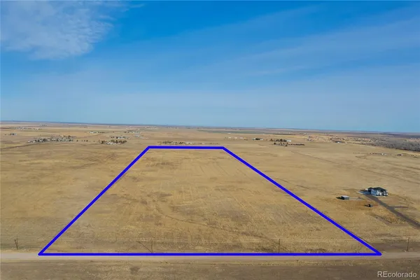 a view of water with wooden floor and fence