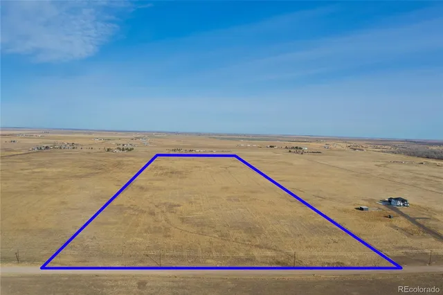 a view of water with wooden floor and fence