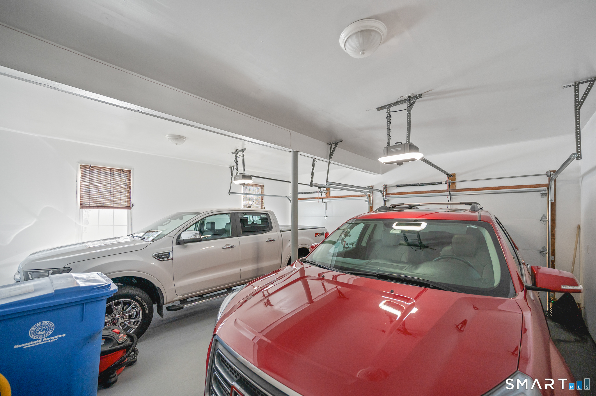 19 Woodside Way Bristol, CT 06010 - Photo 40 of 43 The garage is finished and painted, floor is sealed, and along with new garage doors, there are new wifi enabled openers with cameras for remote monitoring and control