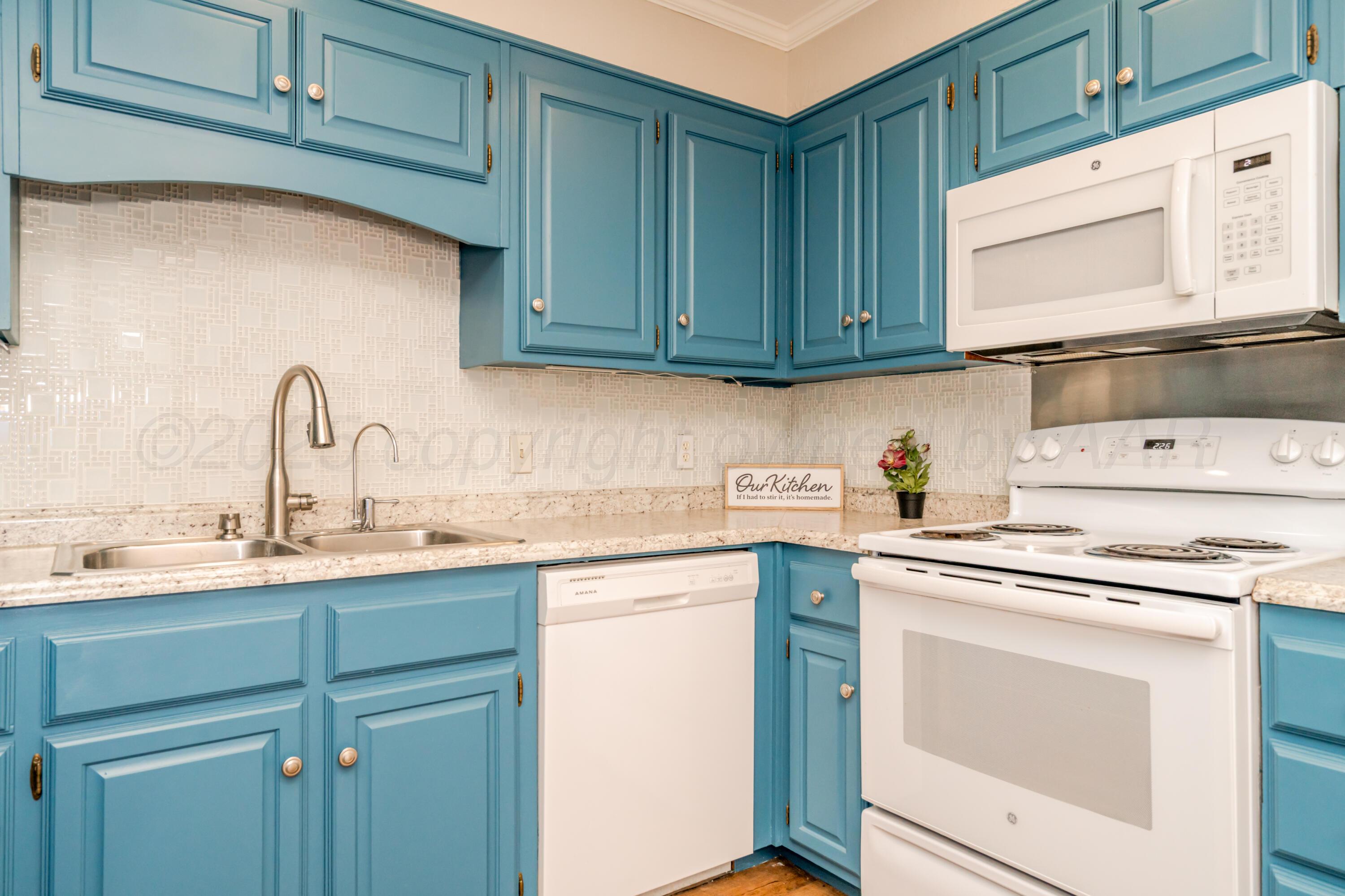 6106 Belpree Road Amarillo, TX 79106 - Photo 16 of 33 a kitchen with cabinets appliances a sink and a counter