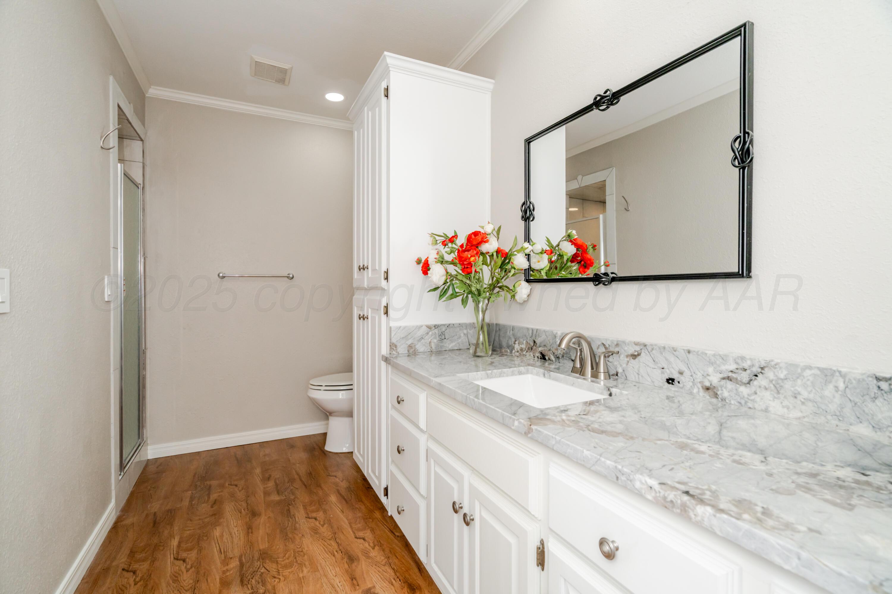 6106 Belpree Road Amarillo, TX 79106 - Photo 24 of 33 a bathroom with a double vanity sink mirror and toilet