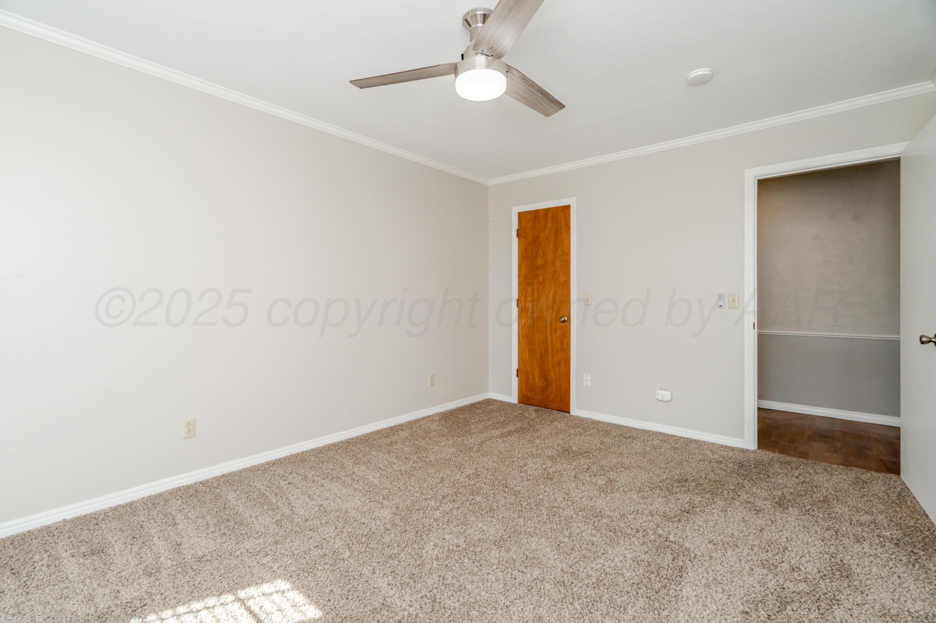 6106 Belpree Road Amarillo, TX 79106 - Photo 27 of 33 an empty room with closet and a chandelier fan
