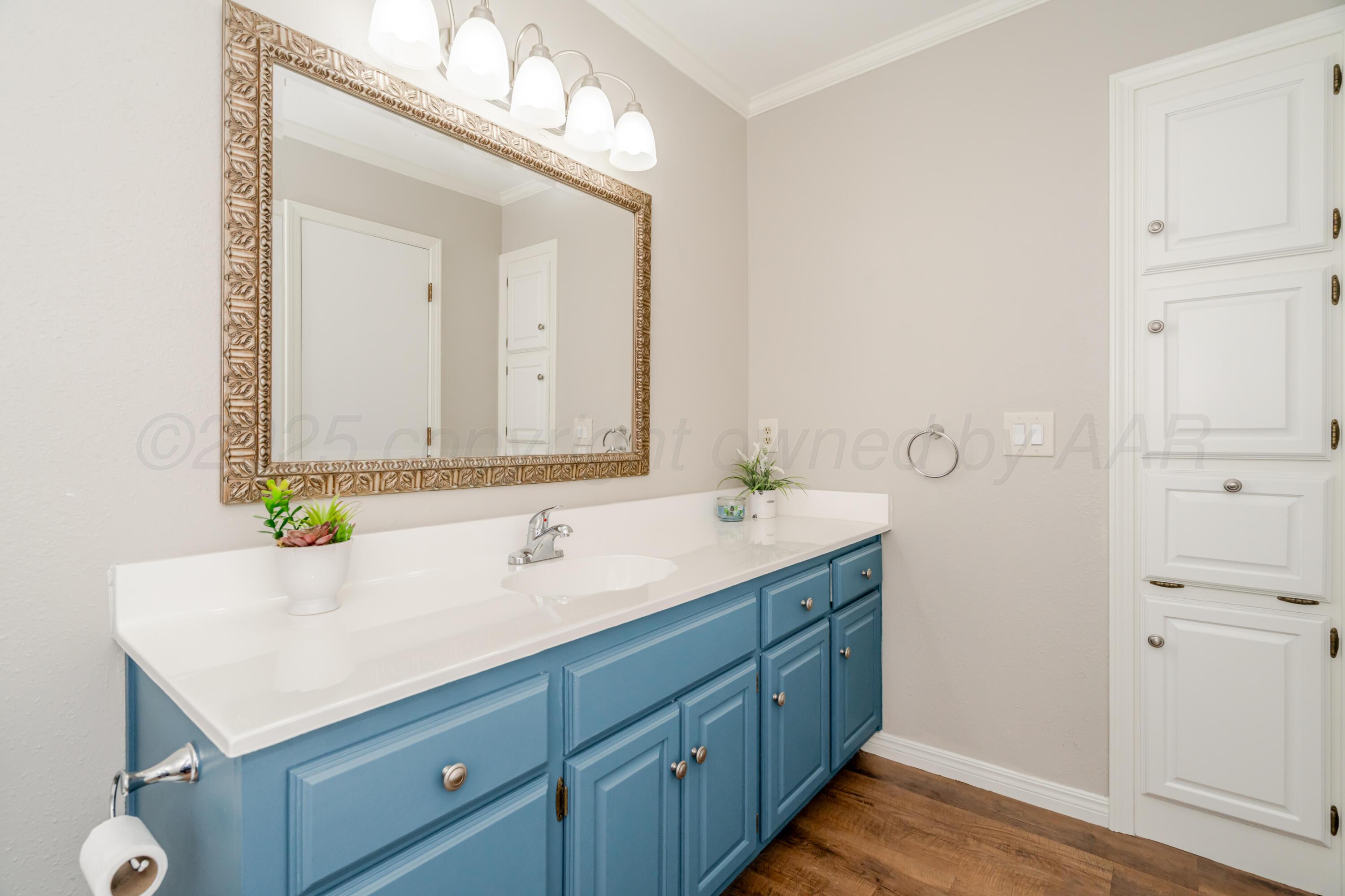 6106 Belpree Road Amarillo, TX 79106 - Photo 28 of 33 a bathroom with a sink and a mirror