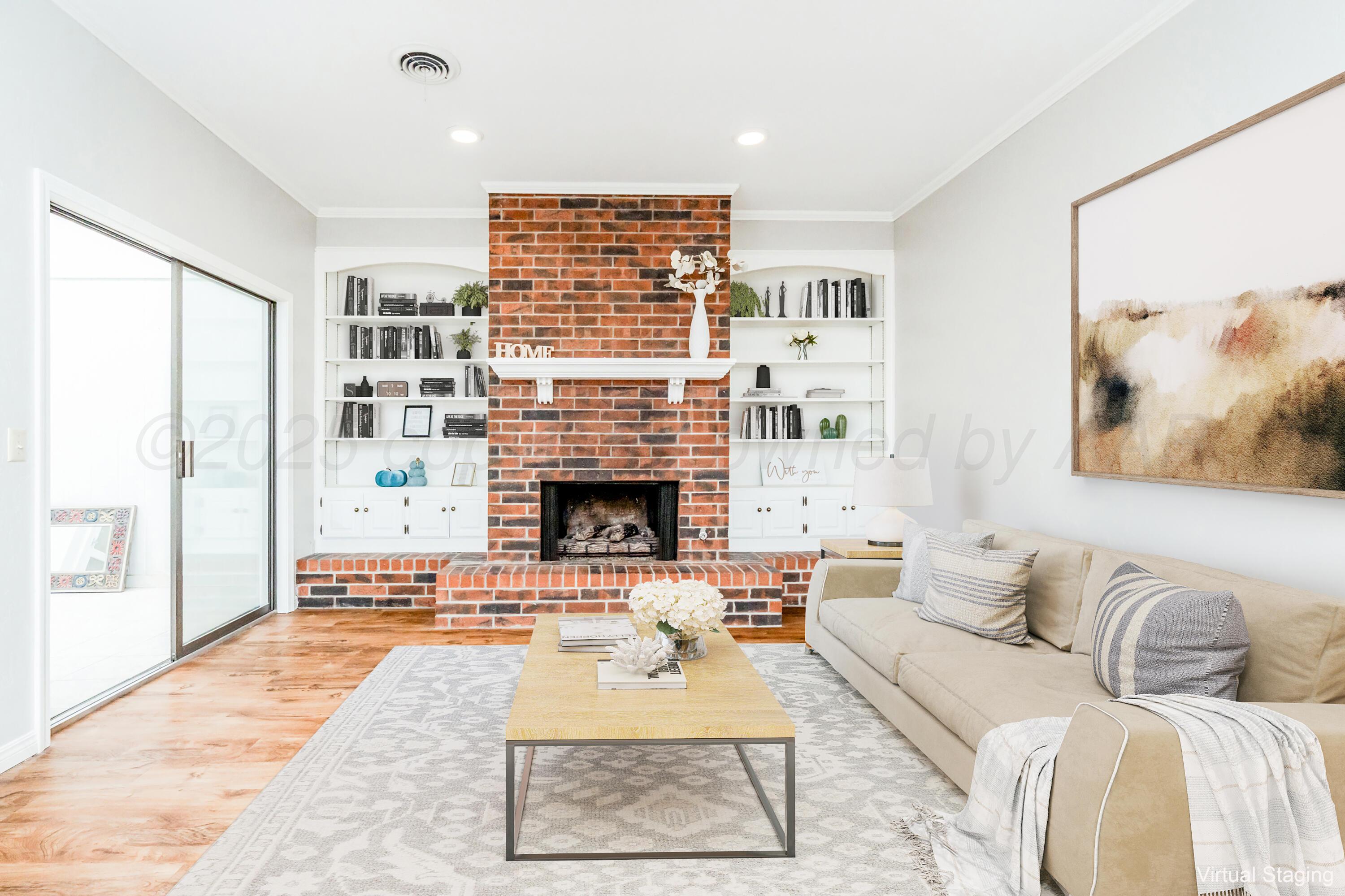 6106 Belpree Road Amarillo, TX 79106 - Photo 3 of 33 a living room with furniture a rug and a fireplace