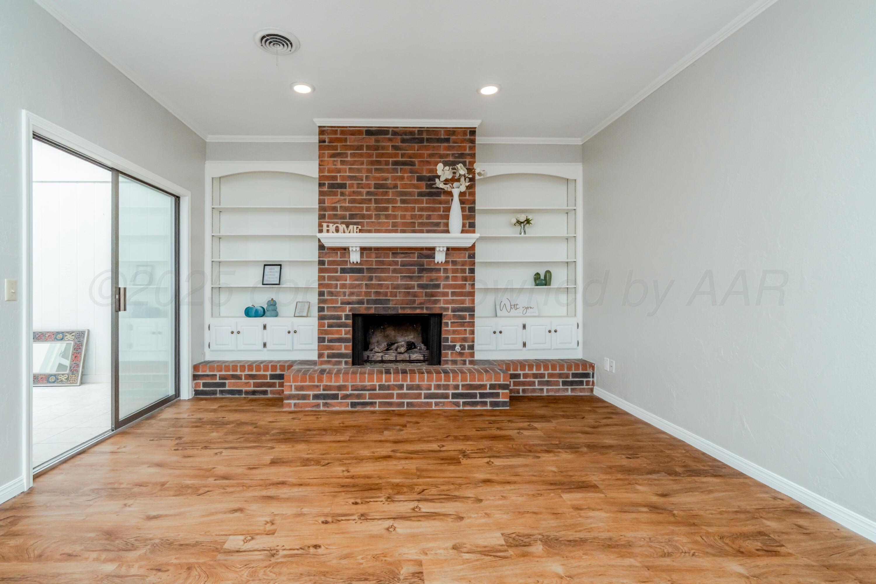 6106 Belpree Road Amarillo, TX 79106 - Photo 4 of 33 a view of empty room with fireplace and window