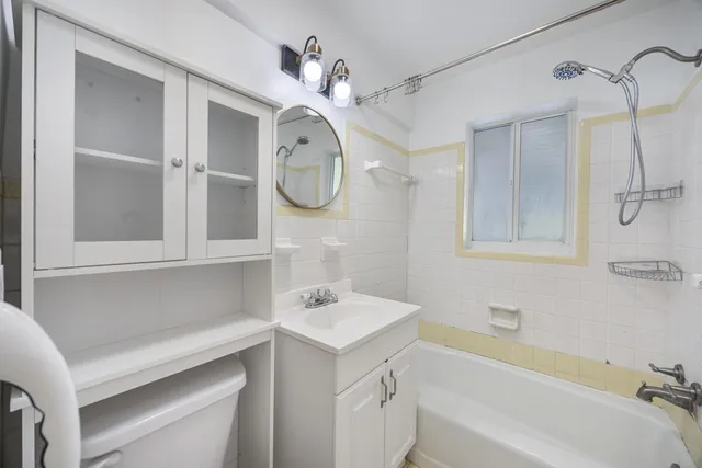 a bathroom with a sink a vanity and a bathtub