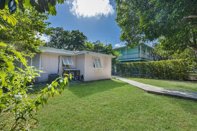 a view of a backyard with plants and a patio