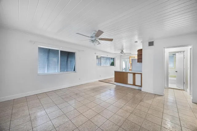 a view of a kitchen with a sink and a cabinet a microwave
