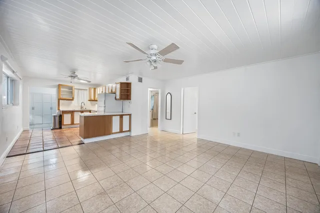 a view of a kitchen with furniture and an empty room