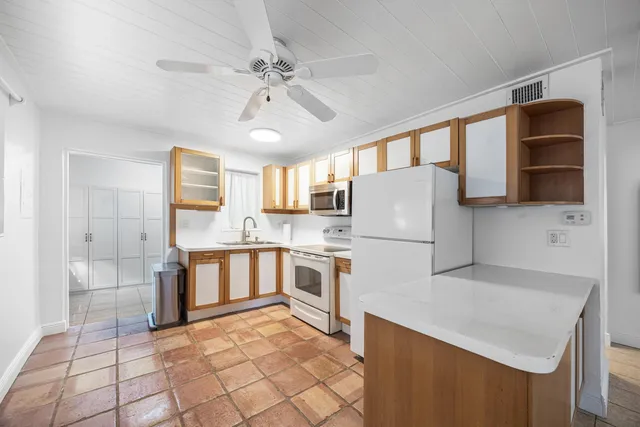 a kitchen with stainless steel appliances a refrigerator sink and cabinets
