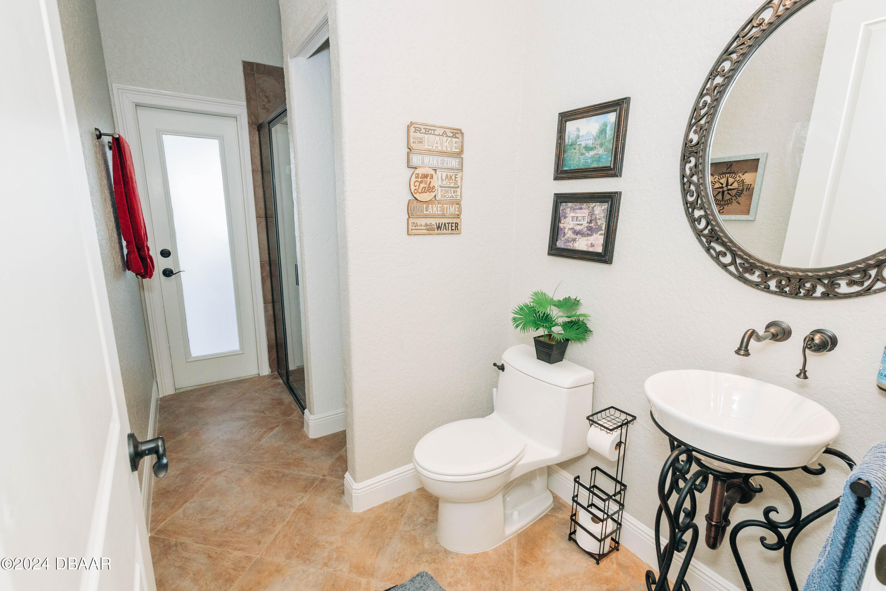 175 Whitcomb Drive Geneva, FL 32732 - Photo 23 of 91 a bathroom with a sink mirror and toilet