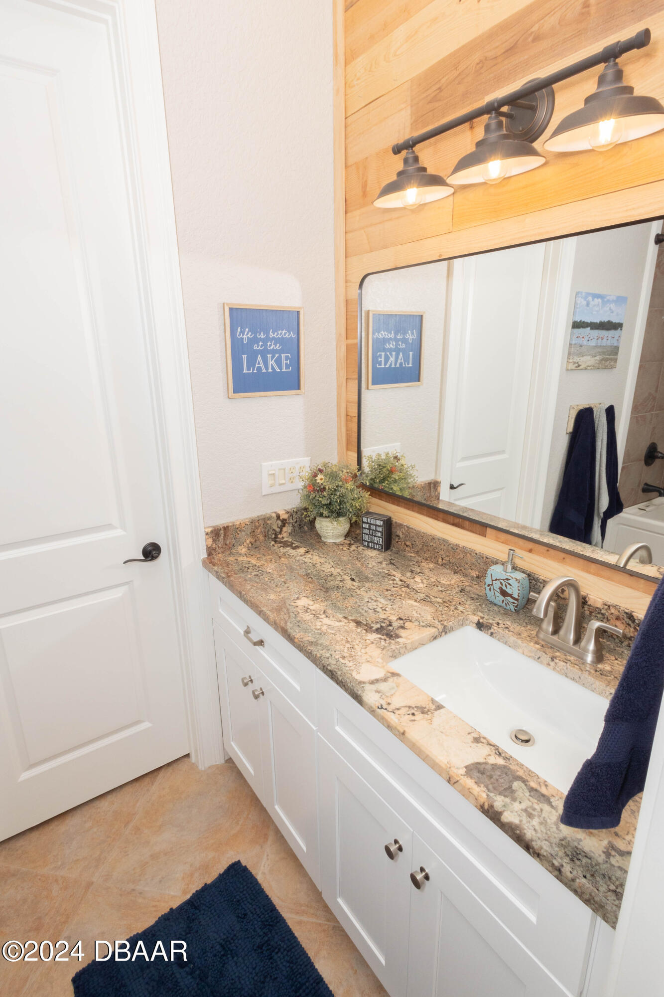 175 Whitcomb Drive Geneva, FL 32732 - Photo 39 of 91 a bathroom with a granite countertop sink and a mirror