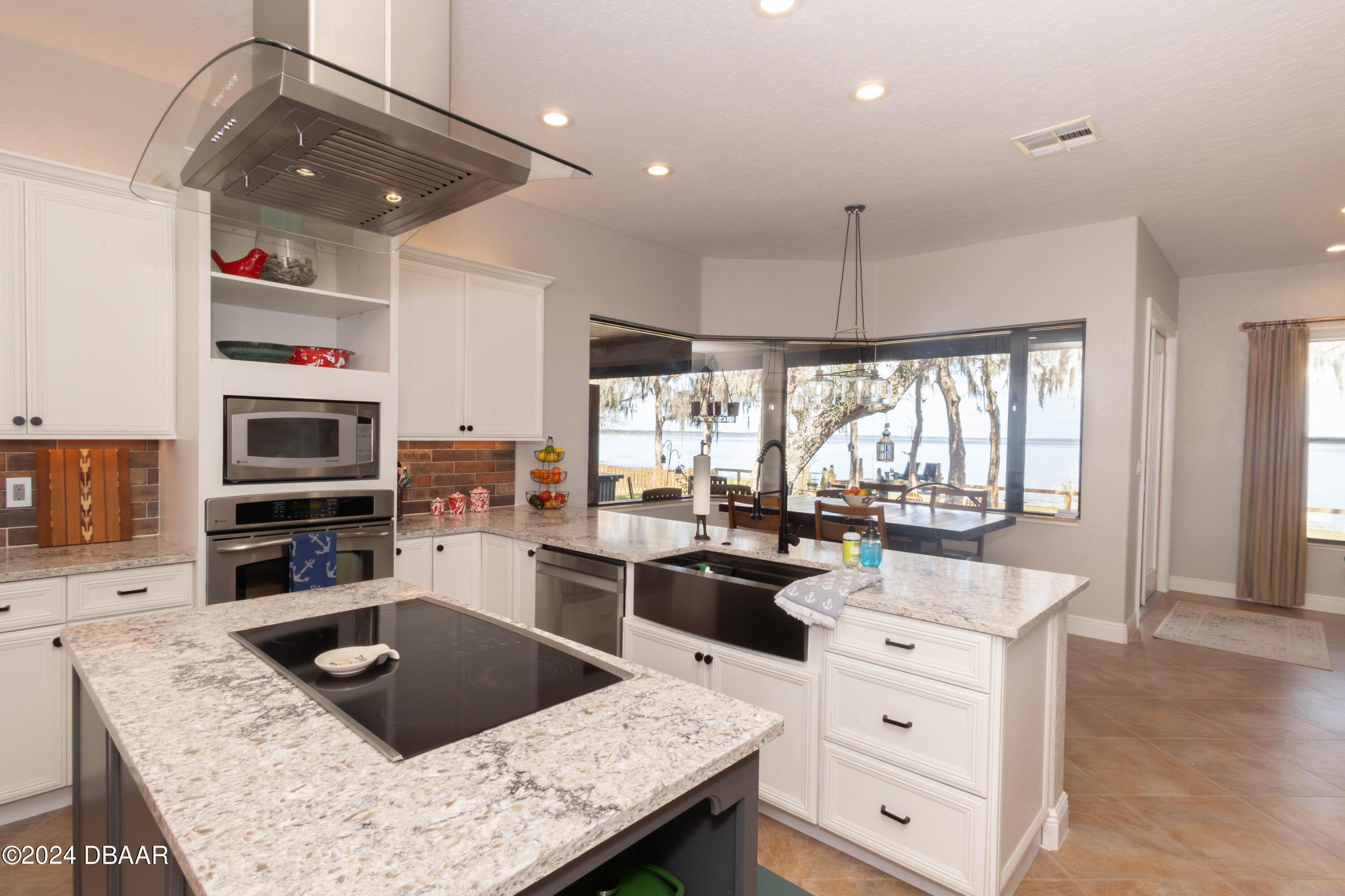 175 Whitcomb Drive Geneva, FL 32732 - Photo 51 of 91 a kitchen with stainless steel appliances kitchen island granite countertop a sink stove and cabinets