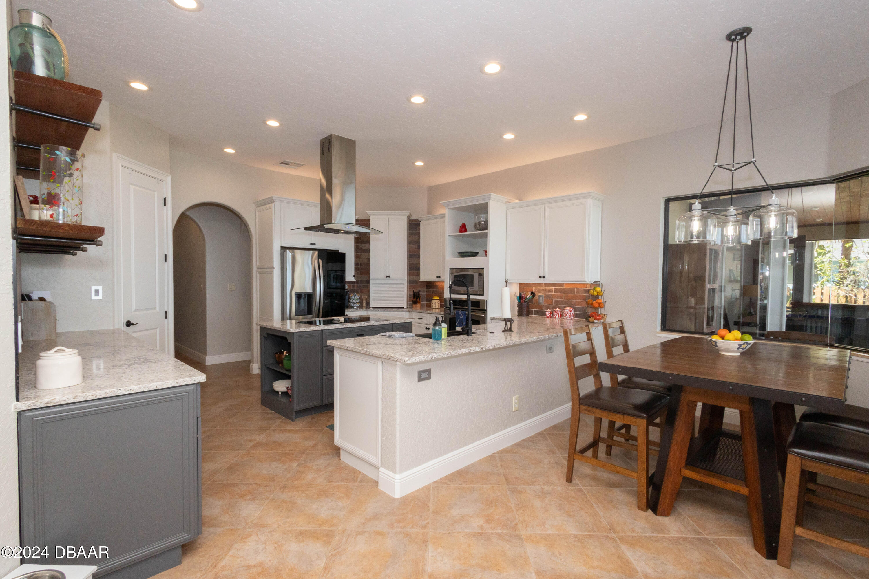 175 Whitcomb Drive Geneva, FL 32732 - Photo 55 of 91 a kitchen with stainless steel appliances kitchen island granite countertop a table chairs sink and cabinets