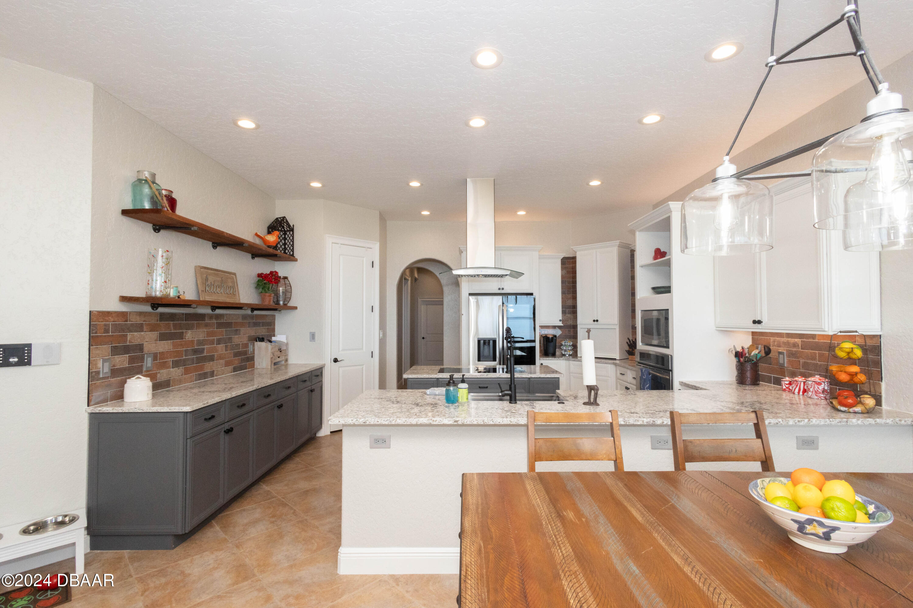 175 Whitcomb Drive Geneva, FL 32732 - Photo 56 of 91 a large kitchen with stainless steel appliances kitchen island granite countertop a large counter top and stove