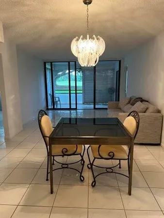 a view of a dining room with furniture and window