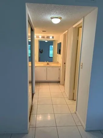 a bathroom with a sink a mirror and a bathtub